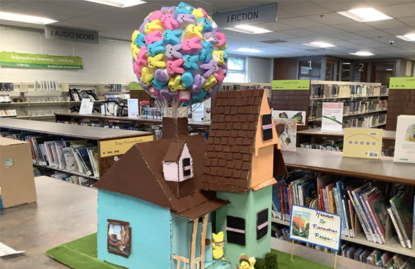 The 2024 Peeple's Choice and Teen category winner "Headed to Paradise Peeps” by Natalie F. It depicts a multi-story house with a "balloon" of Peeps attached to the roof.